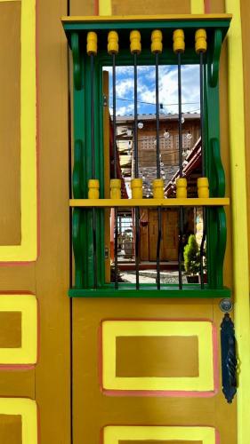 a door with a window in a lego building at La Puesta Del Sol in Filandia