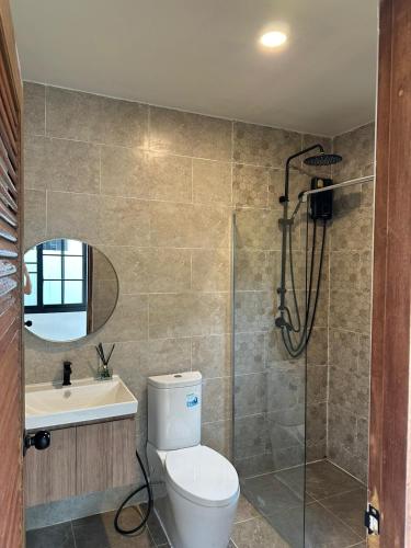 a bathroom with a toilet and a shower and a sink at Chalong Home Phuket in Phuket