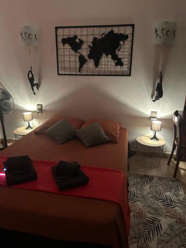 a bedroom with a bed and two tables with lamps at Maison 6 personnes avec piscine terrain arboré clôturé in Vallabrix
