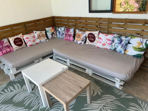 two beds in a room with pillows and a table at Maison 6 personnes avec piscine terrain arboré clôturé in Vallabrix