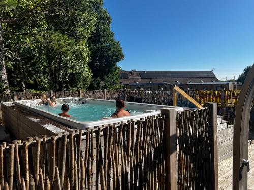 a group of people swimming in a hot tub at Mobil home neuf à étaples à 5 minutes du touquet in Étaples