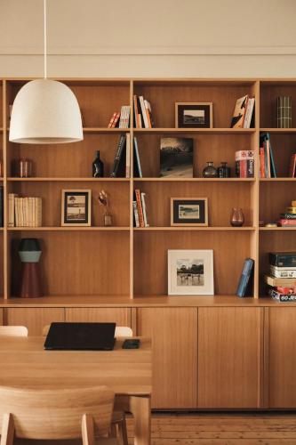 a dining room with a table and a book shelf at Hôtel BelleVue in Bréhat