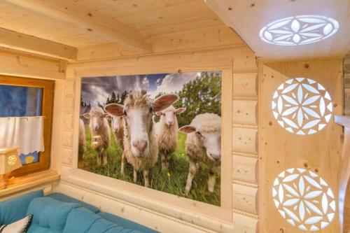 a painting of cows on a wall in a room at Góralska Kryjówka in Zakopane