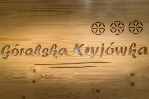 a cake with the words colossia kyrka on a wooden table at Góralska Kryjówka in Zakopane