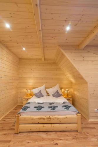 a bedroom with a large bed in a attic at Góralska Kryjówka in Zakopane