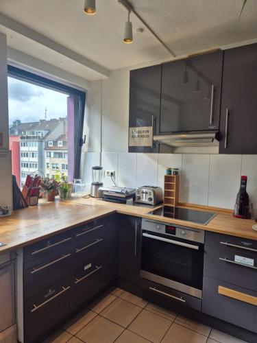 a kitchen with a sink and a stove top oven at Hostel die Wohngemeinschaft in Cologne