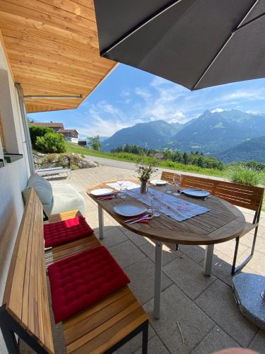 a table and bench with a view of mountains at Haus Zimba Ferienwohnung am Bartholomäberg in Bartholomäberg