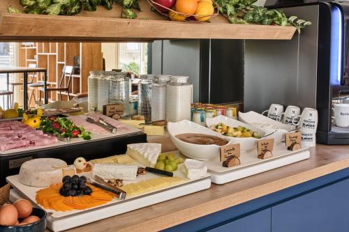 a buffet with different types of food on a table at Kyriad Paris Sud Les Ulis Courtaboeuf in Les Ulis