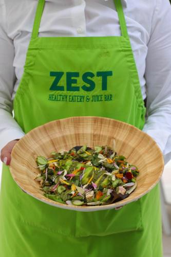 a person holding a bowl of vegetables in a basket at Hyatt Regency Lisbon in Lisbon