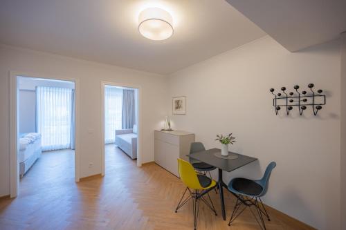 a living room with a table and chairs and a bedroom at Markt22 - Exklusive Stadtapartments in Lingen