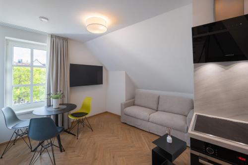 a living room with a couch and a table and chairs at Markt22 - Exklusive Stadtapartments in Lingen