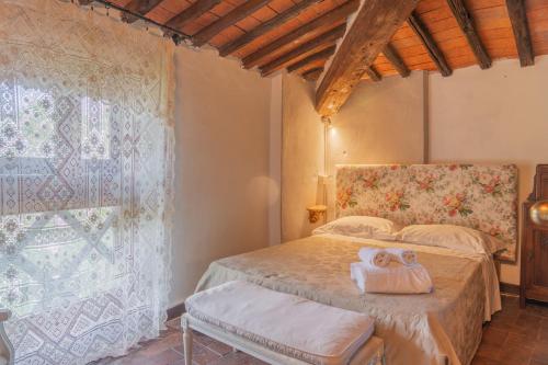 a bedroom with a bed with towels on it at Hotel Villa Sermolli in Borgo a Buggiano