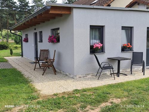 a small house with a table and chairs in a yard at Apartmán Renata Běloves in Náchod
