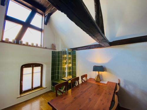 a dining room with a wooden table and a window at Ferienwohnung der Familie Budzisch in Sinsheim