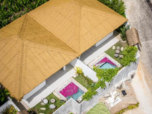 an overhead view of a large umbrella over a pool at Baan Saint-Tropez Seaview Villas Kata Beach in Kata Beach