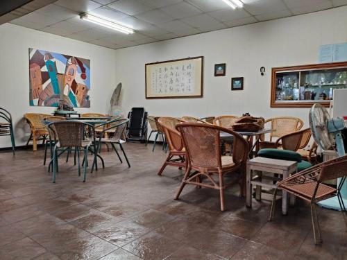 a restaurant with tables and chairs in a room at Meinong Yun Shanju Homestay in Meinong