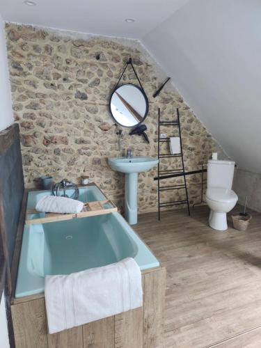 a bathroom with a blue bath tub and a sink at Sophie LE FEUVRE - Soins Energétiques in Baugé-en-Anjou