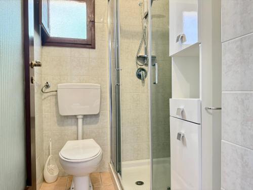 a bathroom with a toilet and a glass shower at Casa Bellini - Cava D'Aliga in Cava dʼAliga