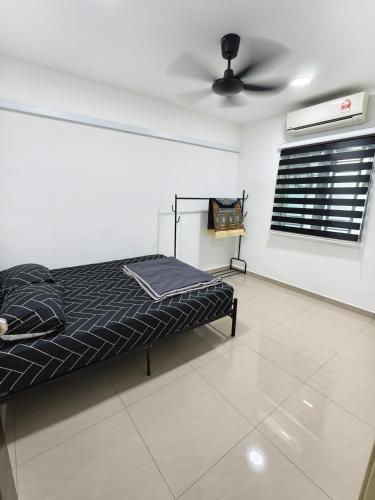 a bedroom with a bed and a ceiling fan at Adra Homestay UTM Taman Sri Pulai in Johor Bahru