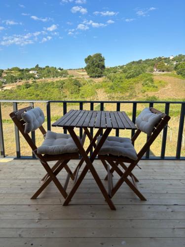 a wooden picnic table and chairs on a deck at Karahan bungalov in Tayakadın