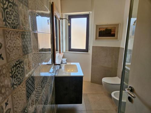 a bathroom with a sink and a toilet at Zafferana Etna House by Holiday World in Zafferana Etnea