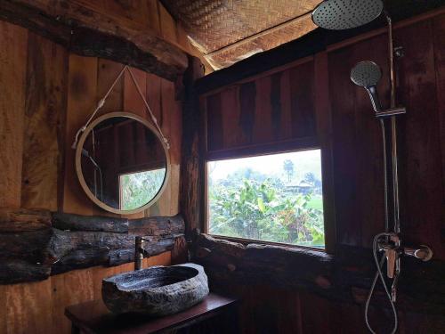 a bathroom with a stone sink and a mirror at Xoi Farmstay - A Home Farm in Lam Thuong valley - North Vietnam in Lung Co (1)