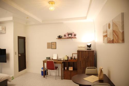 a room with a desk and a table with chairs at Pyeongtaek 1981 in Pyeongtaek