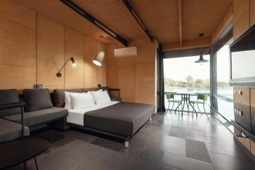 a bedroom with a bed and a couch and a table at GOOD ZONE Hotel in Peschanka