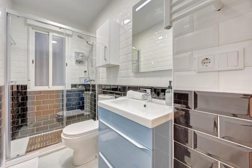 a white bathroom with a toilet and a sink at Maturana by Clabao in Logroño