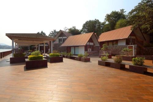a row of houses with plants in a courtyard at Aamby Valley City in Lonavala