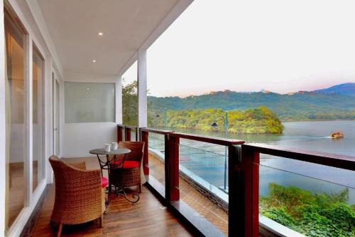 a balcony with a table and a view of a river at Aamby Valley City in Lonavala