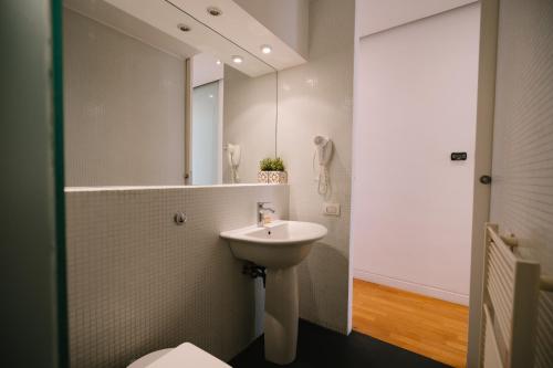 a bathroom with a sink and a mirror at Colosseo Deluxe YH in Rome