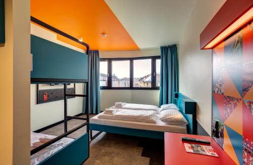 a bedroom with a bunk bed with an orange ceiling at MEININGER Budapest Great Market Hall in Budapest