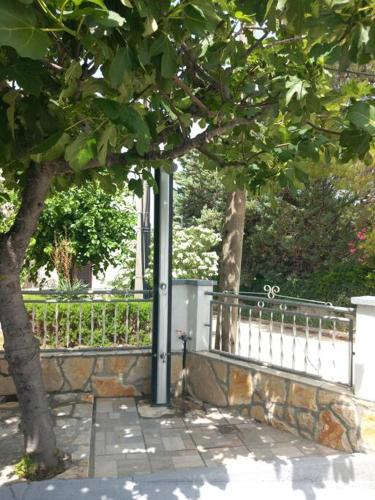 a pole next to a fence and a tree at Apartment Josić in Kaštelina