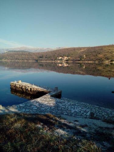a body of water with a dock in the middle at Apartment Josić in Kaštelina