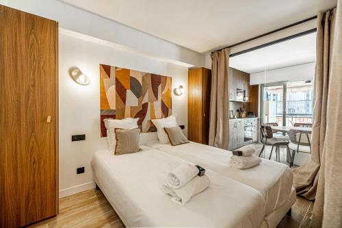 une chambre d'hôtel avec deux lits et un balcon dans l'établissement Charming flat - 2BR-6P - Cannes, à Cannes