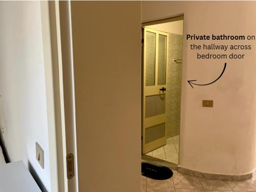a bathroom with a sign on the wall next to a mirror at Rei’s place in Vlorë