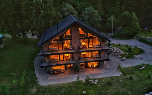 an overhead view of a large house with glass at Apartmány Dolina in Demanovska Dolina