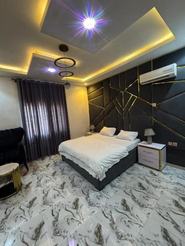 a bedroom with a large bed with a large marble floor at Executive 4 Bedroom Bungalow at New Haven Extension, Enugu in Enugu