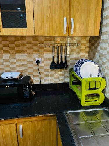 a kitchen counter with a plate rack and a sink at Executive 4 Bedroom Bungalow at New Haven Extension, Enugu in Enugu