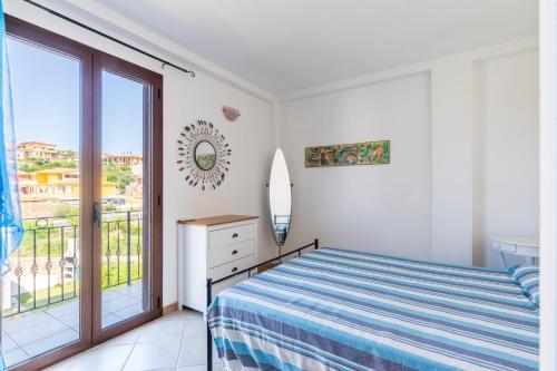 a bedroom with a bed and a balcony at Casa del Sole in Budoni