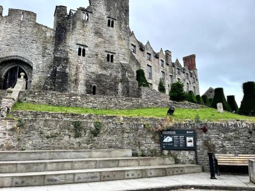 a castle with a bench in front of it at Rooftops in Hay-on-Wye