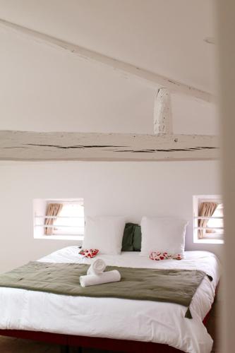 - un lit blanc avec 2 serviettes blanches dans l'établissement Le Clos de la Crouzetterie, à Gaillac