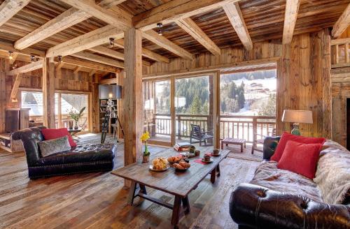a living room with a couch and a table at Chalet de Claude in Morzine - by EMERALD STAY in Morzine