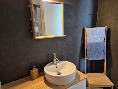 une salle de bain avec un lavabo blanc et un miroir dans l'établissement Urban Sunny & Cosy, à Concarneau