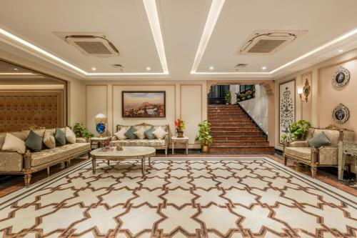 a lobby with couches and a table and stairs at The Residency - A Boutique Hotel in Jodhpur
