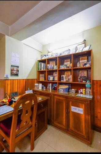 a room with a desk and a table with a chair at sunset nest Drokpas rest heart of Darjeeling in Darjeeling