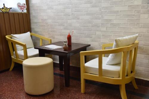 a table with two chairs and a table with at ASHOKA PALACE in Sawāi Mādhopur