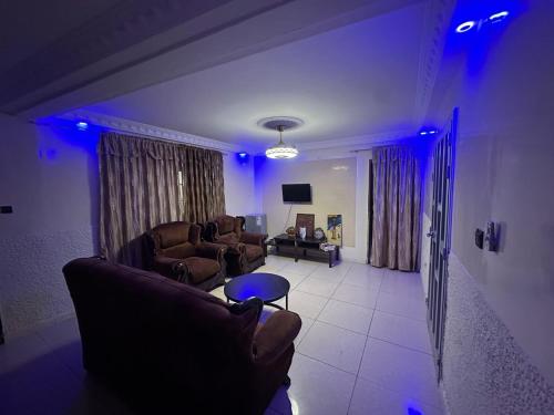 a living room with two couches and blue lights at Welcom family in Saint-Louis