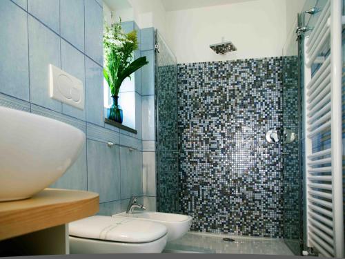a bathroom with a shower and a toilet and a sink at Antonio Massa Lubrense in Massa Lubrense